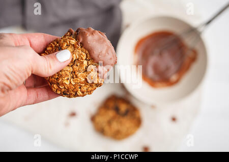 Vegan oatmeal cookies with chocolate on a light background. Food blog style concept. Stock Photo