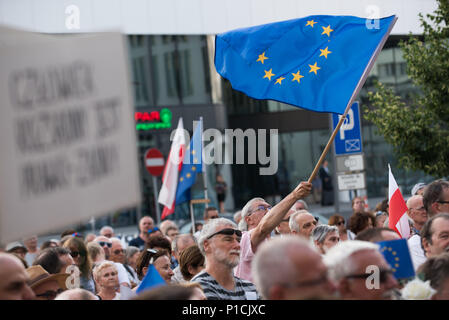 Krakow, Poland. 11th June, 2018. A man waves European Union Flag during a protest in favour of European Commission move urging EU leaders to press forward with disciplinary action against Poland for allegedly violating rule-of-law standards in front of the Courts in Krakow. In December, the European Commission launched an Article 7 disciplinary process, which, in theory, could lead to the suspension of Poland's EU voting right. anges were made until today. The protests a Credit: ZUMA Press, Inc./Alamy Live News Stock Photo