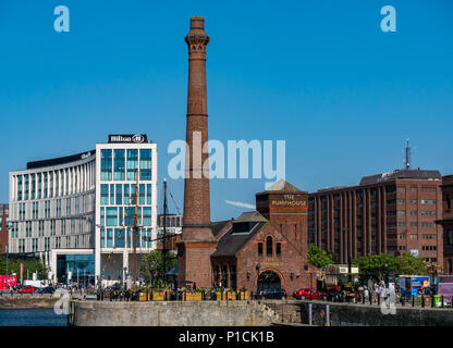 Albert Dock, Liverpool, England, United Kingdom, 11th June 2018. UK weather: sunshine on the Mersey. A beautiful sunny day with clear blue sky along the River Mersey in Liverpool. The dockside Pumphouse pub with people sitting outside and its brick tower, with the modern Hilton Hotel in the background Stock Photo