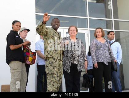 161016-N-VR583-289 PORT-AU-PRINCE, Haiti (Oct. 16, 2016) Rear Adm. Cedric Pringle, commander, Joint Task Force Matthew (JTF-Matthew), speaks with Mari Carmen Aponte, acting assistant secretary, Bureau of Western Hemisphere Affairs, at Toussaint Louveture International Airport. Following the meeting, Pringle transferred command of JTF0Matthew to Rear Adm. Roy I. Kitchener, commander Expeditionary Strike Group TWO. (U.S. Navy photo by Petty Officer 3rd Class Gary J. Ward/Released) Stock Photo