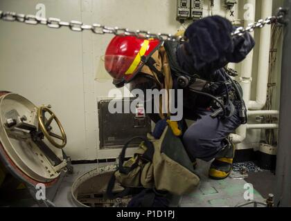 161014-N-GP524-027 ARABIAN GULF (Oct. 14, 2016) Petty Officer 2nd Class Kevin Greider passes inspection gear down a ladder well during a general quarters drill aboard the guided-missile destroyer USS Stout (DDG 55). Greider serves as a boatswain’s mate aboard Stout and assists in all deck operations. Stout, deployed as part of the Eisenhower Carrier Strike Group, is supporting maritime security operations and theater security cooperation efforts in the U.S. 5th Fleet area of operations. (U.S. Navy photo by Petty Officer 3rd Class Bill Dodge) Stock Photo