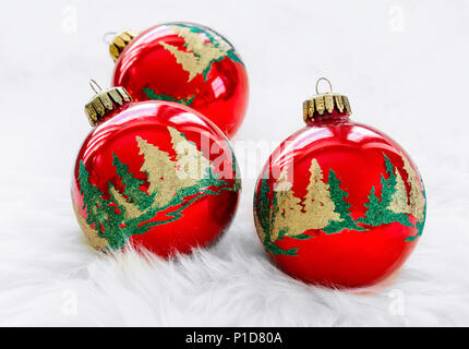 Christmas ornaments laying in white fur. Stock Photo