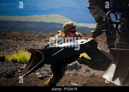 U.S. Marine, Cpl. Cody C. Boyd, assigned to Bravo Battery, 'Black Sheep,' 1st Battalion 12th Marine Regiment, helps push a M777A2 Howitzer during a direct fire training exercise, part of Lava Viper 17.1, at Range 13 aboard the Pohakuloa Training Area, on the big Island of Hawaii, Oct. 16, 2016. Lava Viper is an annual combined arms training exercise that integrates ground elements such as infantry and logistics, with indirect fire from artillery units as well as air support from the aviation element. (U.S. Marine Corps photo by Cpl. Ricky S. Gomez) Stock Photo