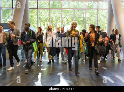 Business people arriving at conference, walking in lobby Stock Photo