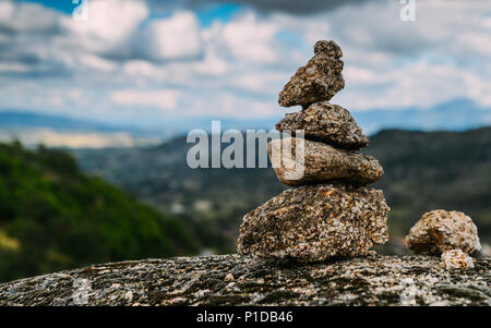 Rock cairn trail marker overlooking a valley in Northeastern Portugal, Europe Stock Photo