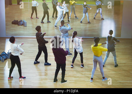 Male instructor leading dance class in studio Stock Photo