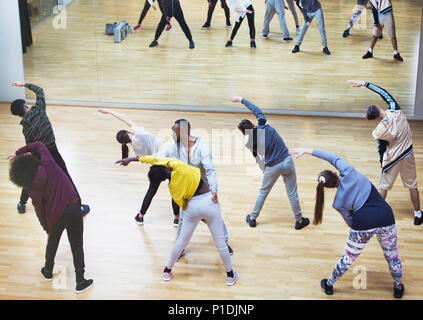 Instructor guiding students in dance class studio Stock Photo