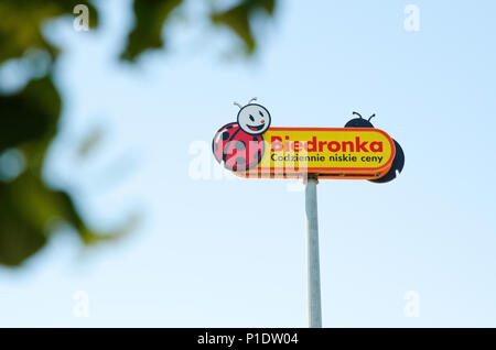 WROCLAW, POLAND - JUNE, 2018. Biedronka's logo on a pole against the blue sky. Biedronka is the largest supermarket chain in Poland and has over 2800  Stock Photo