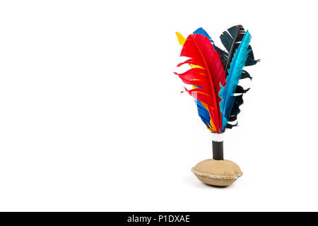 Handmade shuttlecock toy with colourful feathers on white background. Stock Photo