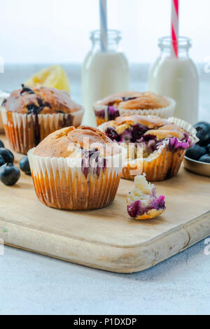 Homemade blueberry and lemon muffins on wooden board Stock Photo