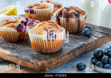 Homemade blueberry and lemon muffins on wooden board Stock Photo