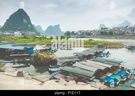 YANGSHUO, CHINA - MAY 26, 2018: Scenic landscape at Yangshuo County of Guilin. Li River (Lijiang River). Pleasure boats at the pier in Yangshuo Town,  Stock Photo