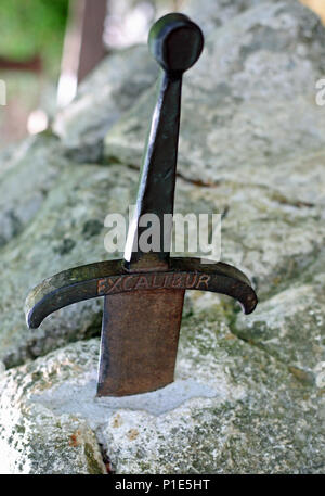 Ancient Magic Sword Excalibur in the stone of King Arthur in Camelot Village Stock Photo