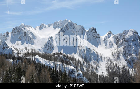 wide panormaric view of moutains with white snow in winter from Lussari Mount in Northern Italy Stock Photo