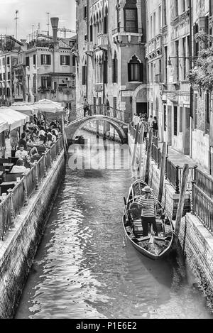 VENICE, ITALY - APRIL 29: Traditional Gondolas with scenic architecture along the canal Rio di S. Provoio, in Castello district of Venice, Italy, Apri Stock Photo