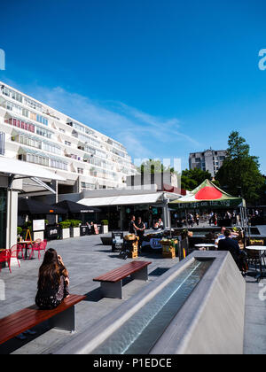 Young Woman, Sitting on Bench, Brunswick Centre, Grade II Listed Building, London, England, UK, GB. Stock Photo