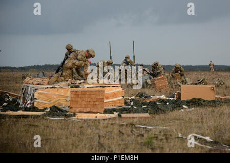 U.S. Paratroopers, assigned to the Bravo Battery, 4th Battalion, 319th Airborne Field Artillery Regiment, 173rd Airborne Brigade, unpack their equipment after a heavy equipment drop into the Bunker drop zone at Grafenwoehr, Germany, Oct. 18, 2016, as part of Peacemaster Unity training. Peacemaster Unity is joint multinational readiness exercise including participation from 7 nations conducting missions across 3 countries, delivering over 2000 troops and 20 heavy drops. The 173rd Airborne Brigade is the U.S. Army Contingency Response Force in Europe, capable of projecting ready forces anywhere  Stock Photo