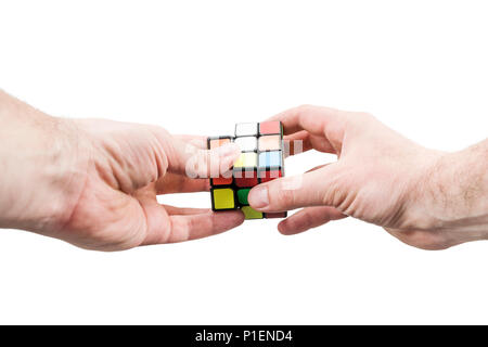 Kharkov, Ukraine - May 31, 2018: Hands collect the Rubik cube Stock Photo