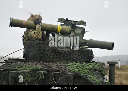 A U.S. Army Paratrooper assigned to Company D, 2nd Battalion, 503rd Infantry Regiment, 173rd Airborne Brigade, loads a BGM-71 Anti-Tank Tow Missile during a weapons range day at Mielno range (north), Drawsko Pomorskie, Poland, Oct. 22, 2016. The “Sky Soldiers” are on a training rotation in support of Operation Atlantic Resolve, where they have joined forces with the Polish 18th Airborne Battalion, 6th Airborne Brigade, to demonstrate deterrence capabilities through airborne assault and combined defensive operations (U.S. Army photo by Sgt. William A. Tanner). Stock Photo