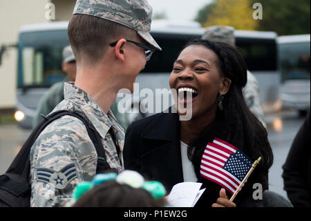 An Airman assigned to the 606th Air Control Squadron reunites with his wife during the squadron’s return to Spangdahlem Air Base, Germany, Oct. 20, 2016. Nearly 200 Airmen assigned to the 606th ACS returned to Spangdahlem Air Base from a six-month rotational deployment to Southwest Asia in support of Operations Freedom’s Sentinel and Inherent Resolve. (U.S. Air Force photo by Airman 1st Class Preston Cherry) Stock Photo