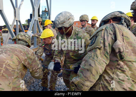 U.S. Army paratroopers assigned to the 173rd Airborne Brigade, 54th Brigade Engineer Battalion and Italian army soldiers from the 2nd Engineer Regiment Pointieri Piacenza, work together to assemble the pieces of the bridge during the Exercise Livorno Shock in Leghorn Army  DEPOT, Italy, Oct. 22, 2016. Livorno Shock is a combined readiness exercise designed to familiarize U.S. paratroopers with river crossing capabilities and is led by the Italian Army’s 2nd Engineer Regiment Pointieri. The 173rd Airborne Brigade is the U.S. Army's Contingency Response Force in Europe, providing rapidly-deployi Stock Photo