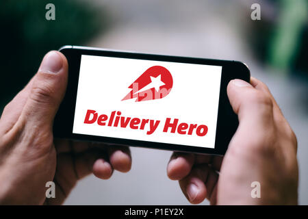 Closeup of iPhone screen with DELIVERY HERO APP LOGO and ICON on smartphone Stock Photo