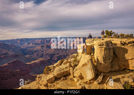 Tourists climbing the big rocks of Grand Canyon National Park Stock Photo