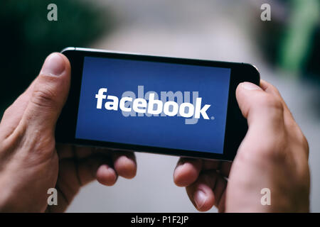 Closeup of iPhone Screen with FACEBOOK LOGO or ICON on smartphone Stock Photo