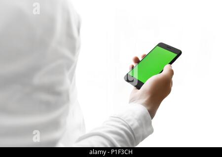 Close-up of male hands using smartphone near the window. Close u Stock Photo