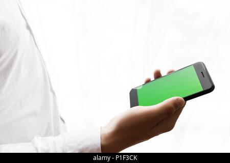Close-up of male hands using smartphone. Chroma Key. Tracking mo Stock Photo
