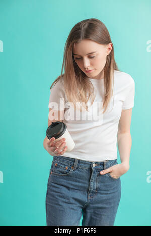 close up side view shot of young woman in casual clothes with plastic coffee cup Stock Photo