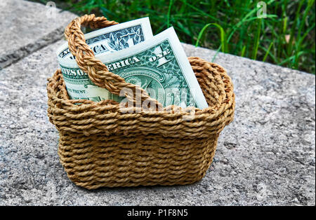 Miniature Basket with One Dollar Bill Stock Photo