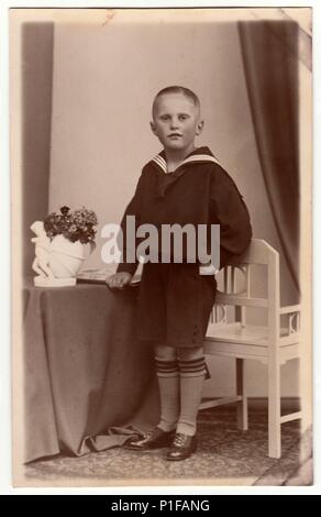 LEIPZIG, GERMANY - CIRCA 1930s: Vintage photo shows a young boy wears sailor costume. Old black & white photo.  Antique studio portrait. 1930s. Stock Photo