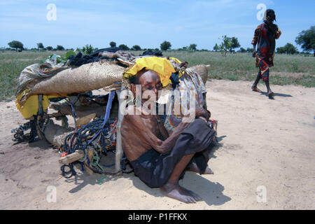 Elderly Tuareg woman with her home in rural Niger, Africa Stock Photo