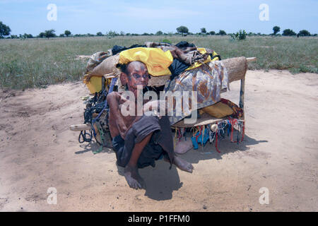 Elderly Tuareg woman with her home in rural Niger, Africa Stock Photo
