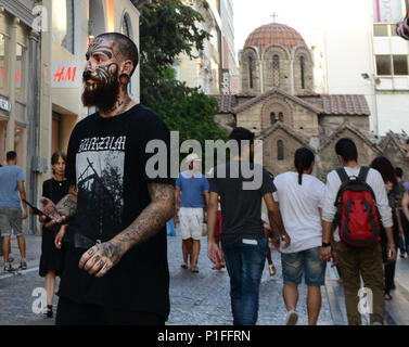 A  Tattooed man walking on  Ermou pedestrian street in  Athens, Greece. Stock Photo