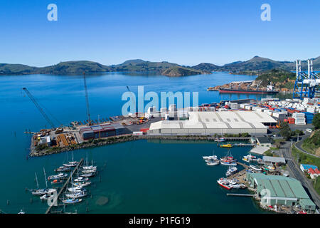 Fishing Boats at Carey's Bay Wharf and Port Chalmers container terminal, Dunedin, Otago, South Island, New Zealand - drone aerial Stock Photo