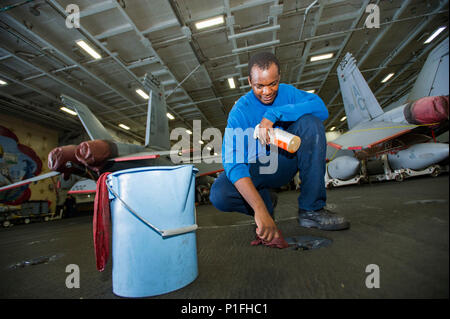 161030-N-WS581-037  ARABIAN GULF (Oct. 30, 2016) Petty Officer 3rd Class Kennedy Ogonda, from Nairobi, Kenya, cleans padeyes in the hangar bay of the aircraft carrier USS Dwight D. Eisenhower (CVN 69) (Ike). Ogonda serves aboard Ike as aviation boatswain’s mate (handling) and is responsible for moving and securing aircraft and overall cleanliness of the hangar bay. Ike and its Carrier Strike Group are deployed in support of Operation Inherent Resolve, maritime security operations and theater security cooperation efforts in the U.S. 5th Fleet area of operations. (U.S. Navy photo by Petty Office Stock Photo