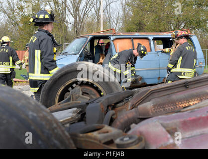 (from left) Kevin Lairson, Richard Breitenstein, Aron Chaney, Thomas Trost, and Kirk Buggert, 788th Civil Engineer Squadron firefighters, evaluate their next step after removing the driver’s side door during vehicle extrication training, Oct. 26, 2016 at Wright-Patterson Air Force Base, Ohio. Vehicle extrication training is conducted routinely throughout the year to ensure crews are ready should the need ever arise. (U.S. Air Force photo by Michelle Gigante) Stock Photo