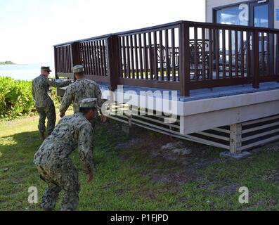 161021-N-ZI127-005 DIEGO GARCIA (Oct. 27, 2016) Petty Officer 2nd Class Jerry Randall, front, Petty Officer 3rd Class Dominic Green, middle, and Chief Petty Officer Aaron Pagan, rear, assigned to Naval Mobile Construction Battalion (NMCB) 5, complete a site survey of a future project at the Officer Club. NMCB 5 is the forward deployed Western Pacific NMCB ready to support Major combat operations and humanitarian assistance/ disaster relief operations and to provide general engineering and civil support to Navy, Marine Corps and joint operational forces. Homeported out of Port Hueneme, Calif.,  Stock Photo