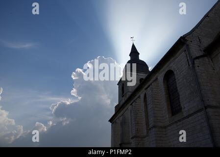 Sunrays: atmospheric coditions highlight the rays of the sun bursting from behind Cumulus cloud Stock Photo