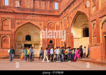 Visitors walking in the courtyard of Jahangiri Mahal in Agra Fort, Uttar Pradesh, India. The fort was built primarily as a military structure, but was Stock Photo