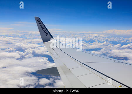 Port wing of Ryanair Boeing 737-800 above the clouds. May 2018 Stock Photo