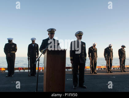 161021-N-OF476-033 PACIFIC OCEAN (Oct. 21, 2016) Chaplain, Lt. Michael Marcelli,  leads a prayer during a burial-at-sea ceremony aboard amphibious assault ship USS Boxer (LHD 4). During the ceremony the cremains of sixteen deceased service members were committed to the sea. Boxer is currently underway conducting routine operations off the coast of Southern California. (U.S. Navy photo by Seaman Eric C. Burgett/Released) Stock Photo