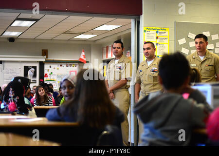 161024-N-VP310-042 WINDSOR, Ontario (Oct. 24, 2016) Sailors assigned to the littoral combat ship USS Detroit (LCS 7) visit with students at the General Brock Public School in Windsor, Ontario during a community service project. The sailors visited elementary school classrooms, answering questions about life in the Navy and the capabilities of the recently commissioned USS Detroit. Detroit was commissioned October 22, 2016. (U.S. Navy photo by Petty Officer 1st Class Richard Hoffner/Released) Stock Photo