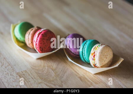 Different color macarons on a table Stock Photo
