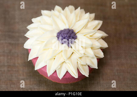 Cupcake with flower design icing Stock Photo