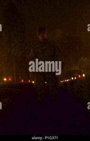 U.S. Army Paratrooper assigned to Company D, 2nd Battalion, 503rd Infantry Regiment, 173rd Airborne Brigade, walks amongst tombstones while participating in an All Saints' Day ceremony in a cemetery at Drawsko Pomorskie, Poland, Oct. 31, 2016. 'Destined' Company Paratroopers and Canadian soldiers assigned to 1st Battalion, Princess Patricia Canadian Light Infantry, attended the annual ceremony where the local populace visited their relatives’ resting place, lit candles, placed flowers and prayed for those who have passed away. The U.S. and partner nations conducted land, sea and air exercises  Stock Photo