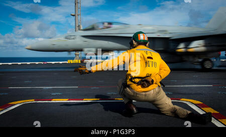 161031-N-HD638-033  PACIFIC OCEAN (Oct. 31, 2016) Lt. Daniel Didier directs an F/A-18C Hornet from the “Blue Blasters” of Strike Fighter Squadron (VFA) 34 during flight operations on the aircraft carrier USS Carl Vinson (CVN 70) flight deck. Carl Vinson is underway conducting Composite Training Unit Exercise (COMPTUEX) off the coast of Southern California. (U.S. Navy Photo by Petty Officer 3rd Class Matthew Brown/Released) Stock Photo