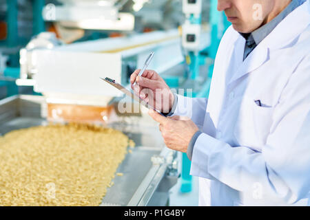 Factory Inspector Taking Notes Stock Photo